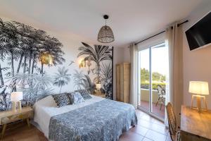 a bedroom with a bed with a mural of palm trees at "Cap Riviera" Hotel & Restaurant Saint Aygulf in Saint-Aygulf