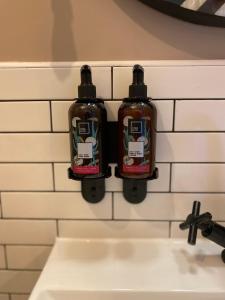two bottles of soap on the wall of a sink at Lonsdale house by Orenda-Luxe in Llandudno