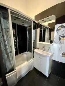 a bathroom with a sink and a shower and a sink at Opera Apart Hotel in Kyiv