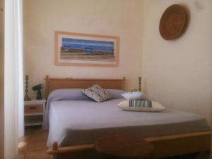 a bedroom with a bed and a picture on the wall at Casa Marianne in Donnalucata