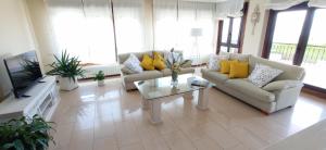 a living room with two couches and a coffee table at Itxi y Jamin - Chalet con vistas a la Ria de Vigo in Moaña