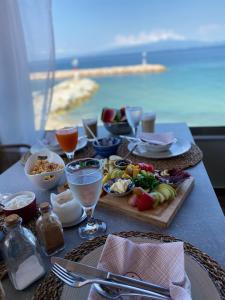 a table with a tray of food on a table with a view at Casa Del Mar Thassos in Skala Sotiros +32 photos