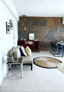 a living room with a couch and a table at Casa Del Mar Thassos in Skala Sotiros
