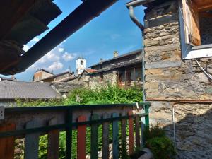 a view from the balcony of a house with a stone building at Widy's House in Bussoleno