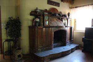 a living room with a fireplace in the corner at Pensjonat Stary Mlyn Tuczno in Tuczno