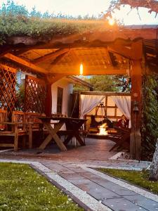 a picnic table under a wooden pergola at Słoneczne Wczasy in Krasnobród