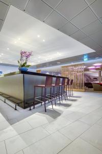 a bar in a hotel lobby with chairs and flowers at Radisson Blu Hotel Oslo Alna in Oslo