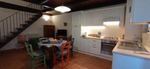 a kitchen with a table and a kitchen with a staircase at Arcadia in Spello