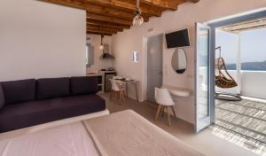 a living room with a couch and a table at Plaka Suites in Plaka Milou