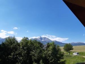 a van parked in a field with mountains in the background at apartman Happy in Stará Lesná