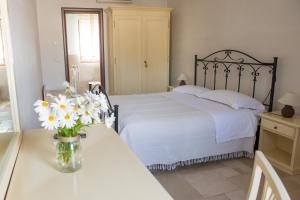 Un pat sau paturi într-o cameră la La Vigna Vecchia