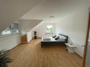 a bedroom with a bed and a wooden floor at Panoramaview near Playmobil & fair Nürnberg in Zirndorf
