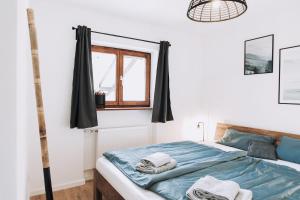 een slaapkamer met een bed met handdoeken erop bij Mountain Mama Ferienhaus in Schliersee