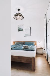 a white bedroom with a bed and a lamp at Mountain Mama Ferienhaus in Schliersee