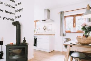 a kitchen and dining room with a stove and a table at Mountain Mama Ferienhaus in Schliersee