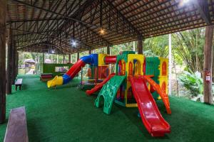 a playground with a slide on a green carpet at Resort Fazenda 3 Pinheiros in Engenheiro Passos