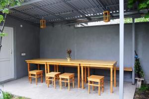 a wooden table and chairs under awning on a patio at Andranik B&B in Goris