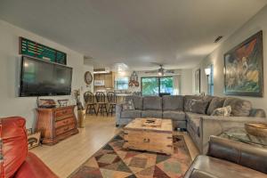 a living room with a couch and a tv at Pine Mountain Lake Haven with Spacious Deck! in Groveland