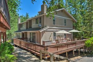 a house with a large deck with chairs and umbrellas at Pine Mountain Lake Haven with Spacious Deck! in Groveland