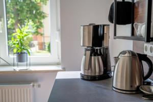a kitchen counter with a coffee maker on a counter top at 4 Sterne Ferienwohnung , 65 qm in Quedlinburg