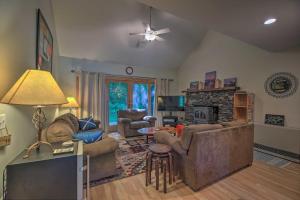 a living room with couches and a fireplace at Rustic Waitsfield Condo about 1 Mi to Hike and Ski! in Waitsfield