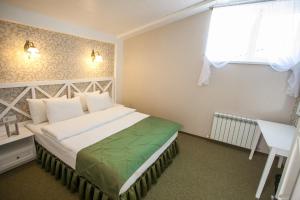 Postel nebo postele na pokoji v ubytování Hotel Litera