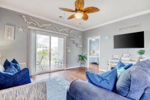 a living room with a blue couch and a tv at Coastal Escape in Myrtle Beach