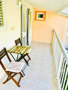 a balcony with a table and a chair at Apartments Paola in Makarska