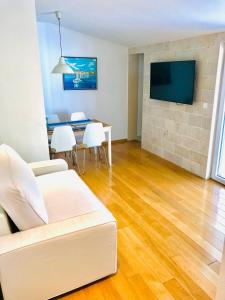a living room with a white couch and a table at Apartments Paola in Makarska