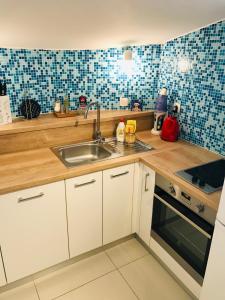 a kitchen with a sink and a stove at Apartments Paola in Makarska