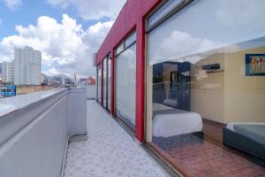 a balcony with a bed and a view of a city at Hotel Ayenda Normandy in Bogotá