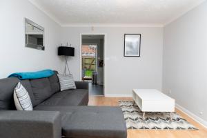 - un salon avec un canapé et une table dans l'établissement A Cosy House Sleeps 7 FREE PARKING Close To The NEC and BHX Airport Three Bedroom House By Be More Homely Serviced Accommodation & Apartments, à Headless Cross