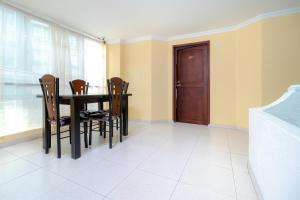 a dining room with a black table and chairs at Hotel Ayenda Normandy in Bogotá