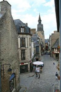 a city street with people walking down a street at Le studio de St-Sauveur in Dinan