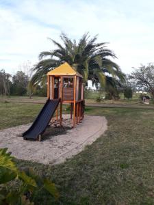 a playground with a slide in a park at Cabañas Los Girasoles in Gualeguaychú