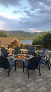 a patio with four chairs and a fire pit at Nordick's Inn in Lake George