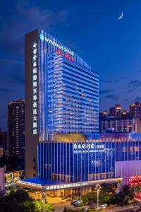 a tall building with blue lights on it at Wyndham Grand Plaza Royale Colorful Yunnan in Kunming