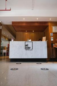 a lobby with a reception desk in a building at Allstay Hotel Semarang Simpang Lima in Semarang