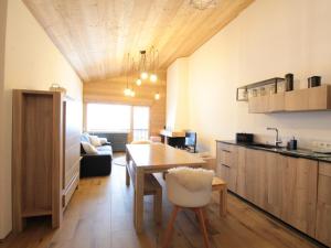 a kitchen and living room with a table and a dining room at Appartement Les Carroz d'Arâches, 3 pièces, 8 personnes - FR-1-572-168 in Les Carroz d'Araches