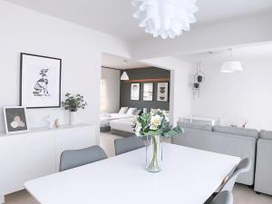 a white dining room with a white table and chairs at OUCHI HOTEL Kanayama-cho with Dogs in Hiroshima