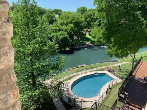 an overhead view of a swimming pool next to a river at Inverness Condos Comal River IC 216 in New Braunfels