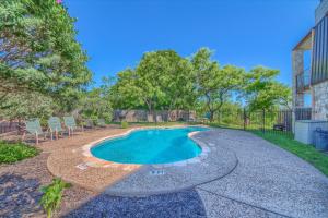 a swimming pool in a yard with chairs and trees at Seele Street River Retreat SS B11 in New Braunfels