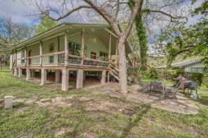 a large green house with a porch and a tree at RR 9084TS Texas Star in Canyon Lake