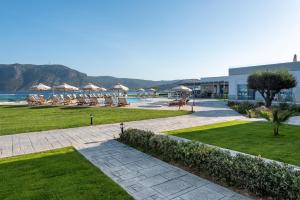 a resort with a lawn and chairs and a pool at Royal Bay Suites in Kefalos
