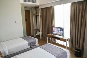 Tempat tidur dalam kamar di Allstay Hotel Semarang Simpang Lima