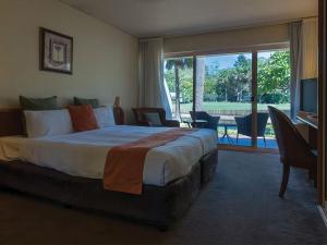 a hotel room with a bed and a table at Pacific Bay Resort in Coffs Harbour