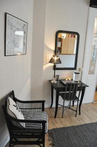 a room with a desk and a chair and a mirror at Wisby Jernväg Hostel in Visby