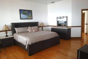 a bedroom with a large bed and a mirror at Pineda Palms Estate, 4 BR for 13 guests, heated pool in Melbourne