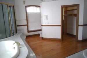 a bathroom with a sink and a toilet and a window at Pineda Palms Estate, 4 BR for 13 guests, heated pool in Melbourne +34 photos