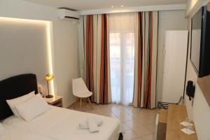 a hotel room with a bed and a television at Alexiou Hotel in Kalabaka